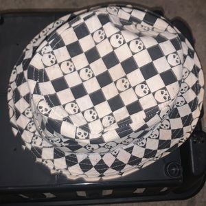 Selling a hat white black checkered with sculls on it